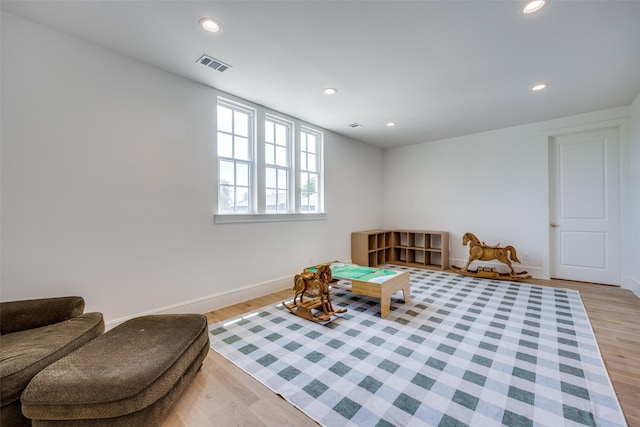 sitting room with light wood-type flooring, visible vents, and recessed lighting