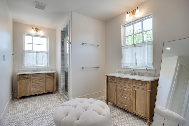 full bath with a wealth of natural light, a shower stall, and vanity