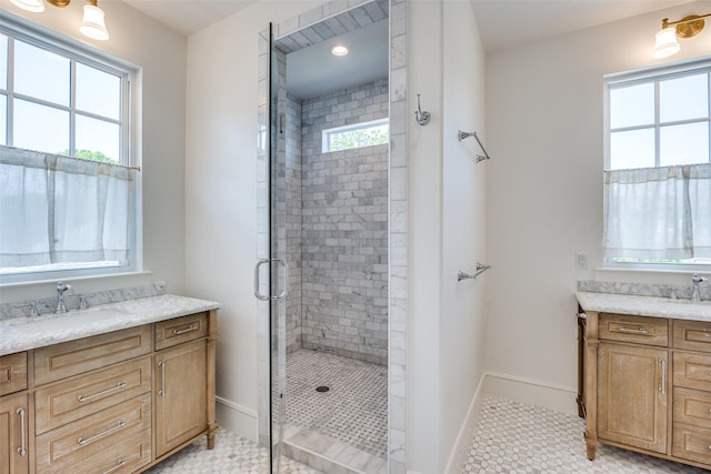bathroom featuring vanity, baseboards, and a shower stall