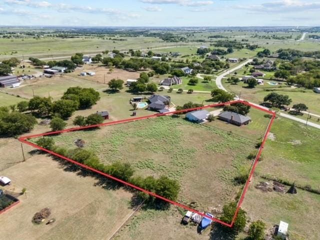 birds eye view of property with a rural view