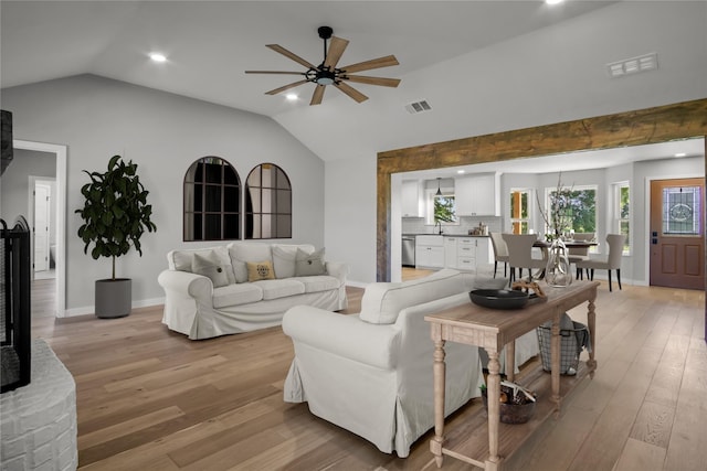 living room with lofted ceiling, recessed lighting, light wood finished floors, ceiling fan, and visible vents