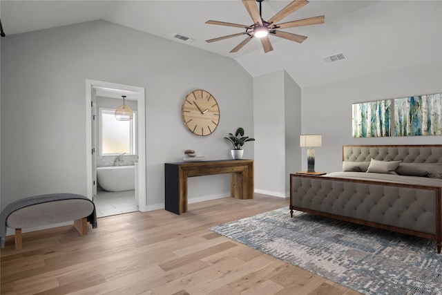bedroom featuring light wood finished floors, lofted ceiling, and visible vents