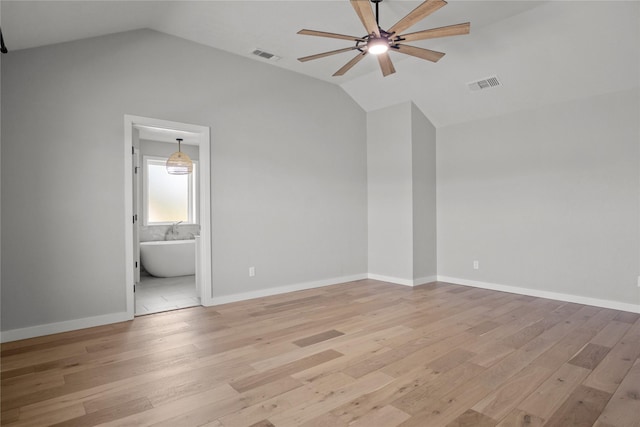 unfurnished bedroom featuring light wood-type flooring, visible vents, and lofted ceiling