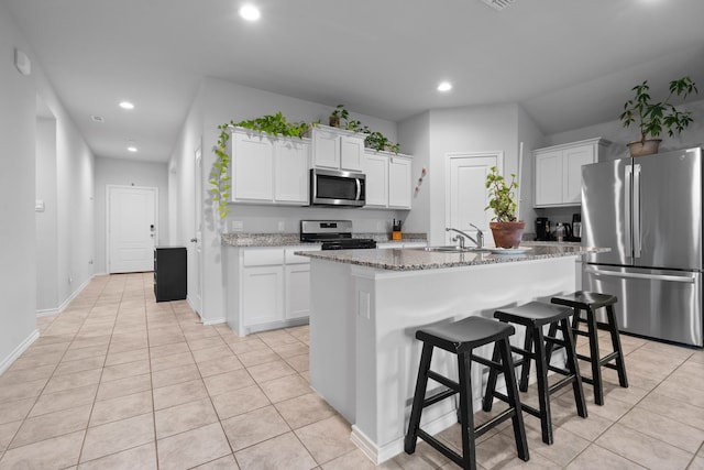 716 Emmons Creek St, Justin, TX 76247 - kitchen featuring recessed lighting, light tile patterned flooring, a sink, white cabinetry, and appliances with stainless steel finishes