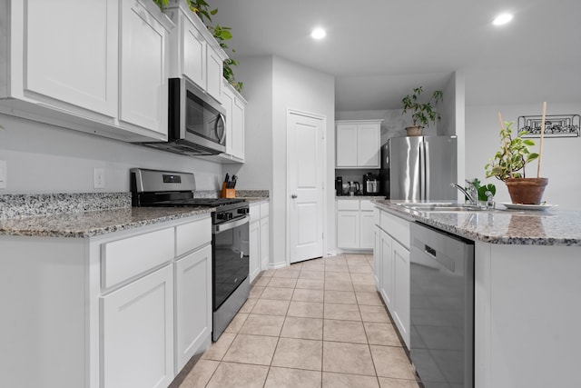716 Emmons Creek St, Justin, TX 76247 - kitchen featuring a sink, recessed lighting, light tile patterned floors, white cabinets, and appliances with stainless steel finishes
