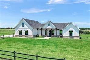 modern farmhouse featuring fence and a front yard