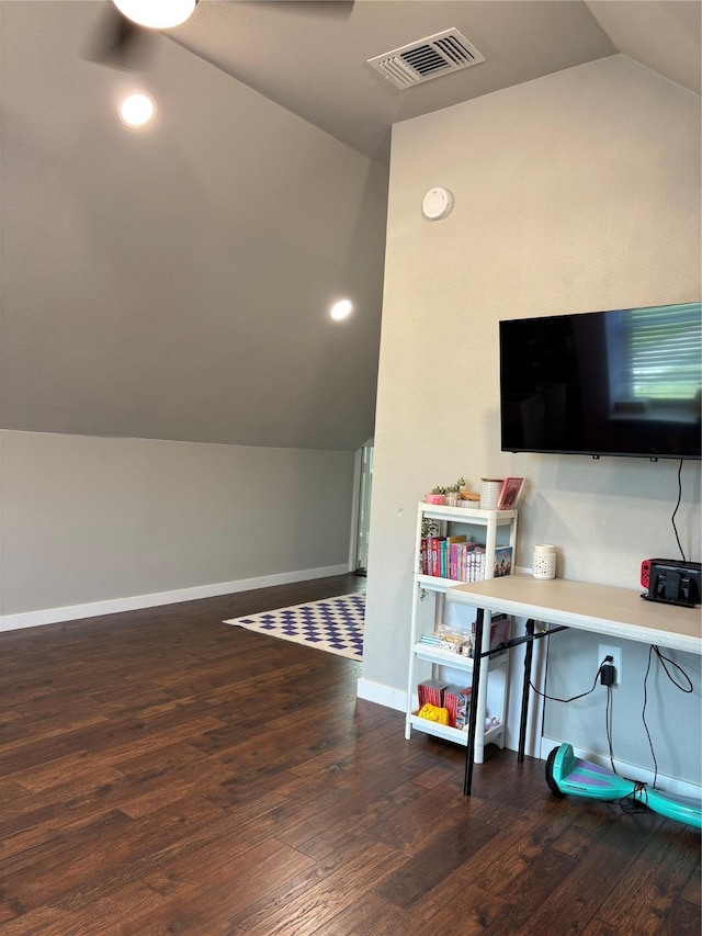 rec room featuring baseboards, visible vents, wood finished floors, and lofted ceiling