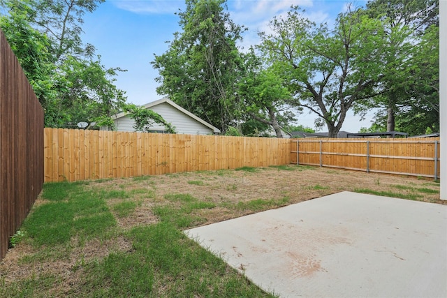 view of yard with a fenced backyard and a patio area