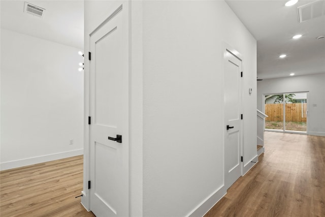 hall with recessed lighting, baseboards, visible vents, and wood finished floors