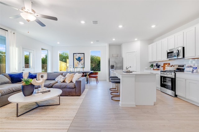 1805 Golden Sq, Cedar Hill, TX 75116 - interior space featuring appliances with stainless steel finishes, recessed lighting, visible vents, open floor plan, and light wood-type flooring