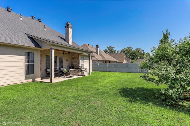 view of yard featuring a patio, fence, and ceiling fan