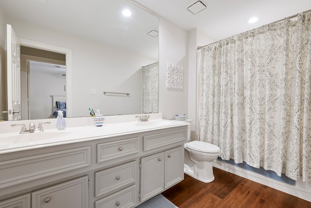 5125 Golden Ln, Fort Worth, TX 76123 - full bath featuring double vanity, toilet, wood finished floors, and a sink