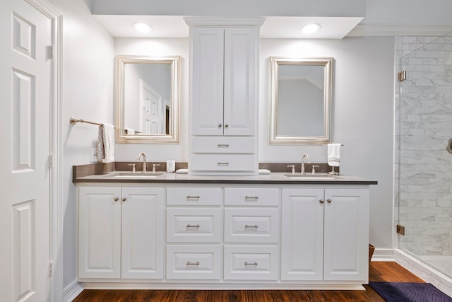 5125 Golden Ln, Fort Worth, TX 76123 - full bath with double vanity, wood finished floors, a stall shower, and a sink