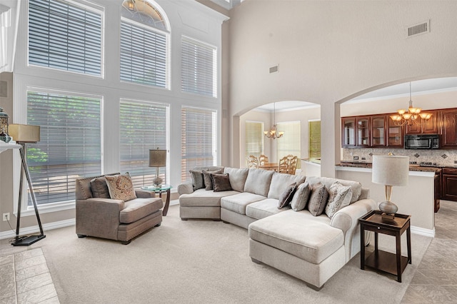 4600 Winter Park Dr, Richardson, TX 75082 - living room with a chandelier, arched walkways, a high ceiling, and baseboards