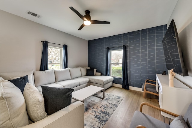 807 Florence St, Mckinney, TX 75069 - living area featuring light wood-type flooring, ceiling fan, visible vents, and a wealth of natural light
