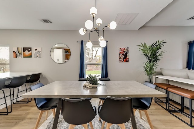 807 Florence St, Mckinney, TX 75069 - dining area with a healthy amount of sunlight, a chandelier, light wood-type flooring, and visible vents