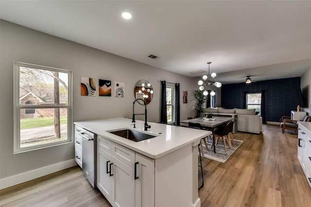 807 Florence St, Mckinney, TX 75069 - kitchen with dishwasher, visible vents, a sink, white cabinetry, and open floor plan