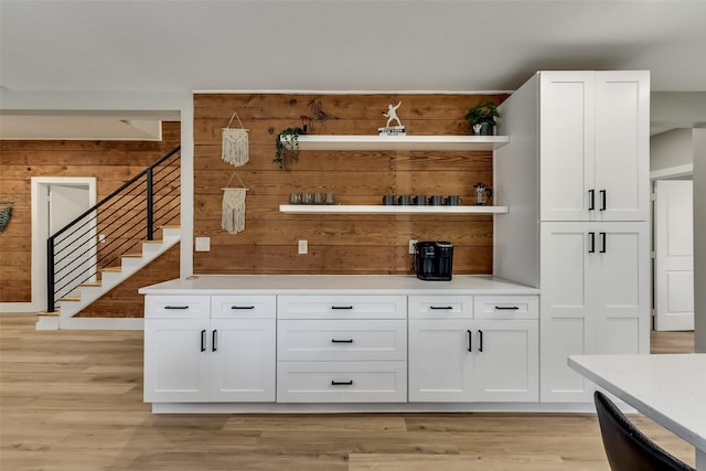 807 Florence St, Mckinney, TX 75069 - bar with light wood finished floors, stairway, and wood walls