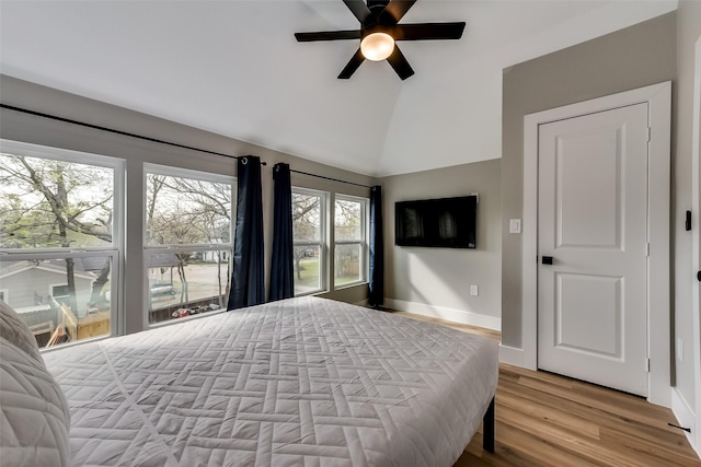 807 Florence St, Mckinney, TX 75069 - bedroom with baseboards, high vaulted ceiling, ceiling fan, and wood finished floors