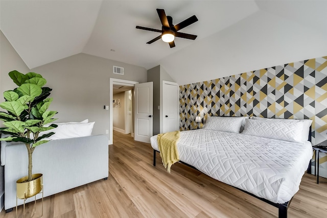 807 Florence St, Mckinney, TX 75069 - bedroom featuring lofted ceiling, baseboards, visible vents, an accent wall, and light wood-type flooring