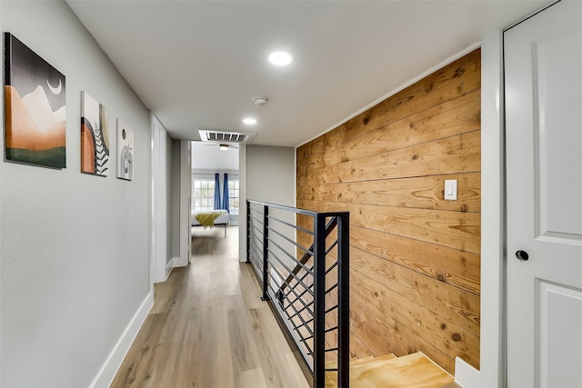 807 Florence St, Mckinney, TX 75069 - hall featuring baseboards, visible vents, wooden walls, an upstairs landing, and light wood-type flooring