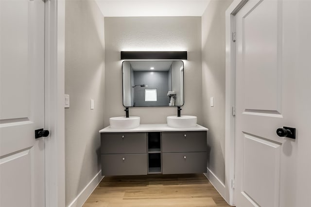 807 Florence St, Mckinney, TX 75069 - full bathroom with baseboards, a sink, and wood finished floors