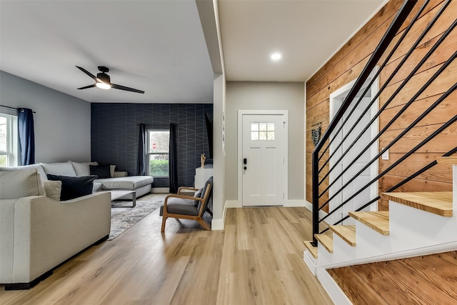 807 Florence St, Mckinney, TX 75069 - living area featuring an accent wall, ceiling fan, stairway, baseboards, and light wood-style floors