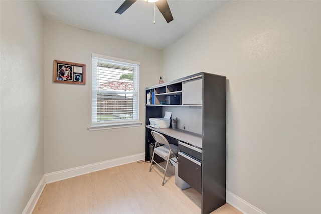 office area featuring a ceiling fan, baseboards, and light wood-type flooring