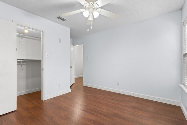 304 E Clover Park Dr, Fort Worth, TX 76140 - unfurnished bedroom with a closet, wood finished floors, visible vents, a spacious closet, and baseboards