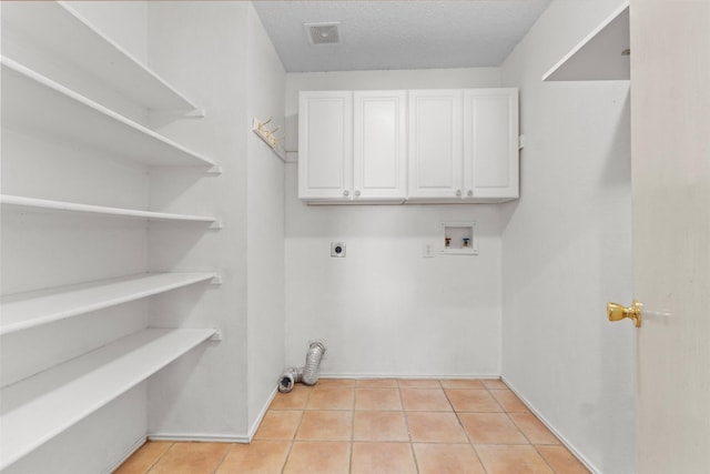 304 E Clover Park Dr, Fort Worth, TX 76140 - laundry area featuring light tile patterned flooring, washer hookup, visible vents, cabinet space, and electric dryer hookup
