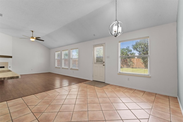 304 E Clover Park Dr, Fort Worth, TX 76140 - foyer entrance with baseboards, ceiling fan with notable chandelier, a textured ceiling, and vaulted ceiling