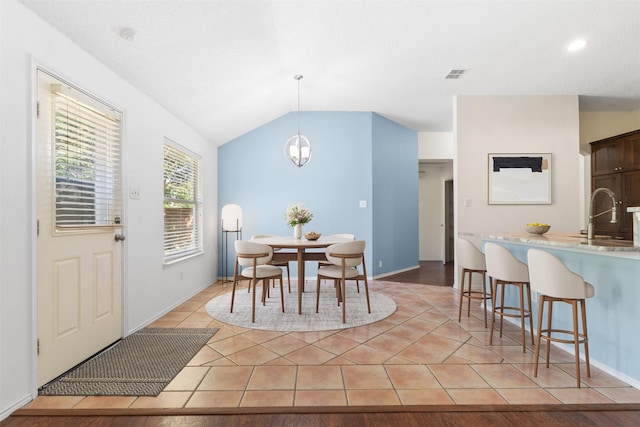 304 E Clover Park Dr, Fort Worth, TX 76140 - dining area featuring lofted ceiling, baseboards, light tile patterned floors, and visible vents