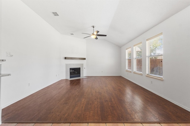 304 E Clover Park Dr, Fort Worth, TX 76140 - unfurnished living room featuring a ceiling fan, a tiled fireplace, visible vents, vaulted ceiling, and wood finished floors