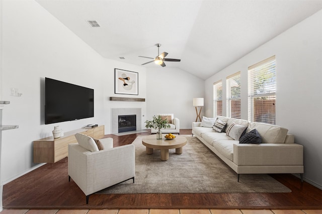304 E Clover Park Dr, Fort Worth, TX 76140 - living area with a tile fireplace, wood finished floors, a ceiling fan, visible vents, and vaulted ceiling