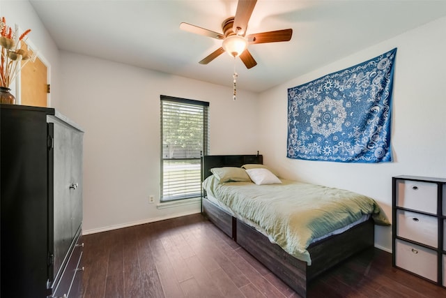 bedroom featuring baseboards, wood finished floors, and a ceiling fan