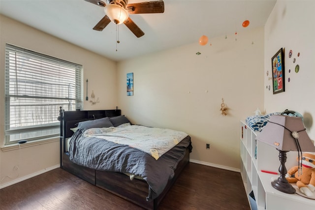 bedroom featuring baseboards, wood finished floors, and a ceiling fan