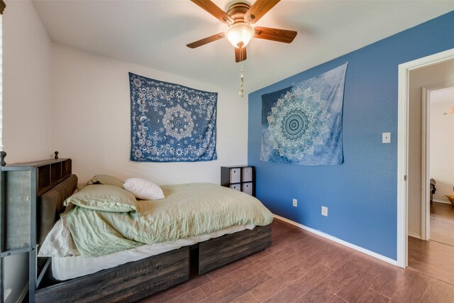 bedroom with wood finished floors, baseboards, and ceiling fan