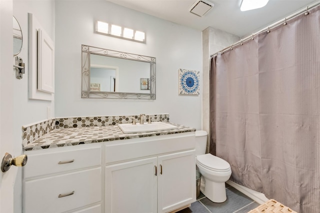 full bathroom featuring toilet, vanity, and curtained shower