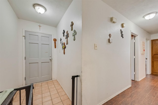 hallway with baseboards and light wood-style floors