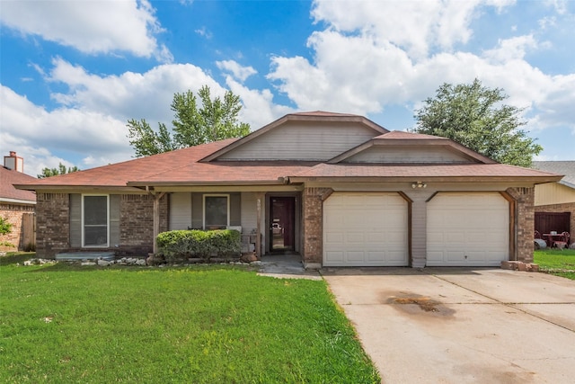 view of front facade featuring an attached garage, a front yard, and brick siding