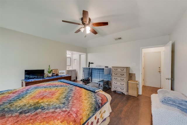bedroom featuring wood finished floors, a ceiling fan, and connected bathroom