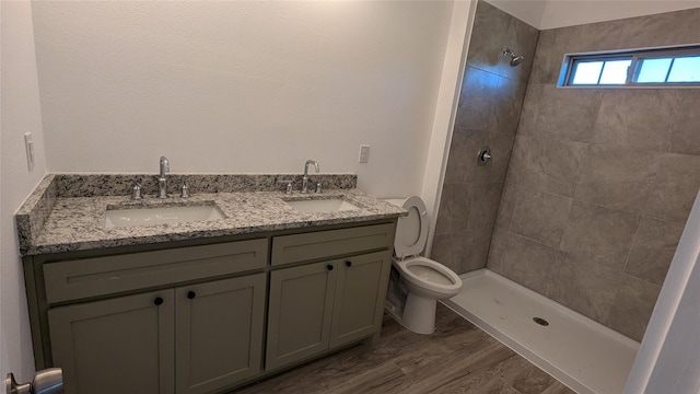 106 Sugar Ter, Runaway Bay, TX 76426 - bathroom featuring a sink, toilet, wood finished floors, and a tile shower
