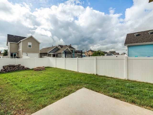 1909 Myers Ct, Providence Village, TX 76227 - view of yard featuring a fenced backyard, an outdoor fire pit, a patio, and a residential view