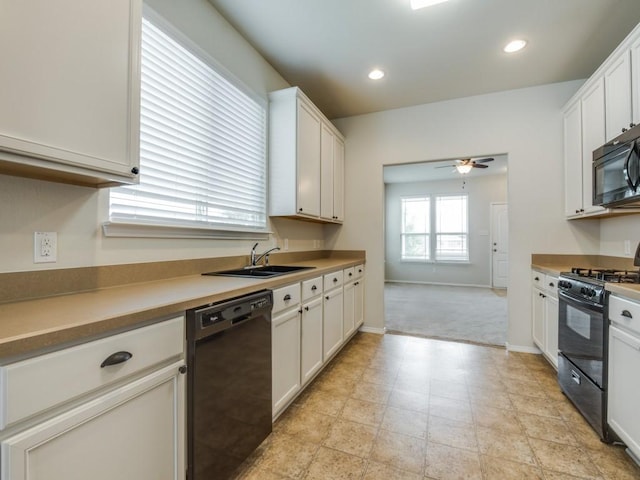 1909 Myers Ct, Providence Village, TX 76227 - kitchen with a ceiling fan, black appliances, white cabinetry, and a sink