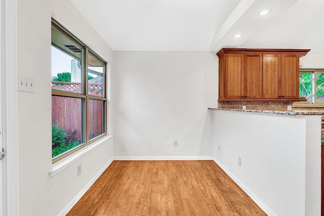 interior space with baseboards, light wood finished floors, and recessed lighting