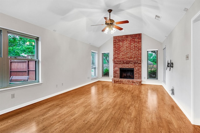 unfurnished living room featuring a ceiling fan, a healthy amount of sunlight, and wood finished floors