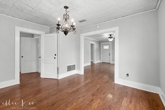 741 Vine St, Abilene, TX 79602 - unfurnished room featuring crown molding, a chandelier, wood finished floors, an ornate ceiling, and ceiling fan