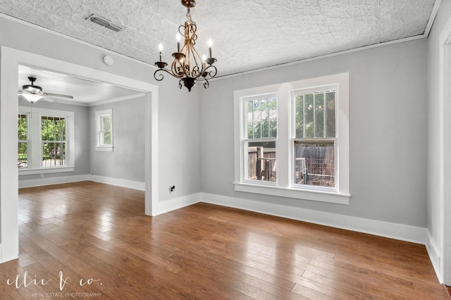 741 Vine St, Abilene, TX 79602 - empty room with ornamental molding, an ornate ceiling, a chandelier, dark wood finished floors, and baseboards