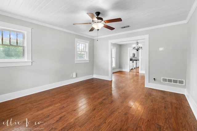 741 Vine St, Abilene, TX 79602 - empty room featuring a chandelier, healthy amount of natural light, a ceiling fan, dark wood-style flooring, and crown molding