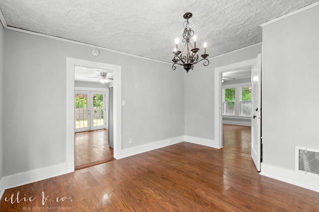 741 Vine St, Abilene, TX 79602 - spare room with ceiling fan, crown molding, wood finished floors, a chandelier, and baseboards